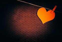Vignetting Photo of Red Heart Shape on the Rope on the Old Background closeup