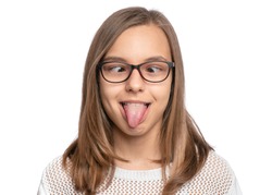 Crazy child making grimace - Silly face, shows tongue. Funny caucasian teen girl in eyeglasses, isolated on white background. Close-up portrait.