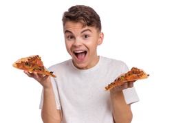 Happy handsome young teen boy holding slice of pizza. Close up portrait of smiling child with delicious Italian pizza, isolated on white background. Guy looks at camera and shows fast food.