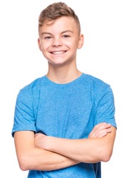 Half-length emotional portrait of caucasian teen boy wearing blue t-shirt. Funny teenager with arms folded, isolated on white background. Handsome child looking at camera.