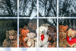 Group of  teddy bears sitting in a window set up for a bear hunt