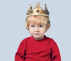 Portrait of a little boy prince wearing a crown