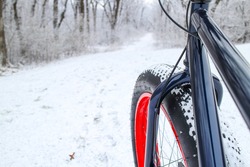 Winter biking on a Fat tire bike. Shallow focus. Focus on Bicycle Fork.