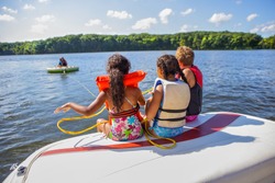 Family tubing from a boat on an inland lake