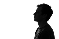 black-and-white silhouette of head of sad caucasian man on a white isolated background