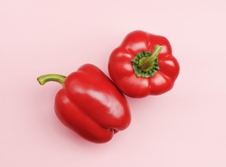 Two red Bell peppers isolated on pink background. Minimal healthy food concept. Detox menu set, Spicy meal veg fruit cook. Art design card shot above table. Flat lay view close up copy space for text.
