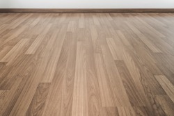 A room with pale wood parquet floor.
