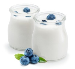 Two glass containers with plain yoghurt and berries isolated on white background.