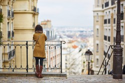 Female tourist enjoying city view on a street of Montmartre, Paris, France