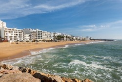 Shoreline view of Quarteira city beach on the Algarve region, Portugal.