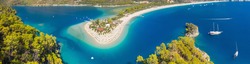 aerial wide angle panorama of famous resort Oludeniz in Turkey with sand beach and yachts