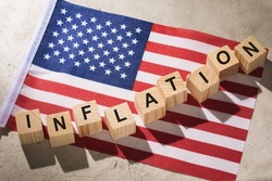 USA flag and wooden cubes with text, concept on the theme of inflation in America