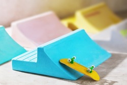 Multicolored plaster ramps and yellow fingerboard on an abstract background