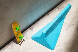 Blue plaster ramp and yellow fingerboard on abstract background