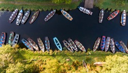 aerial view of small fishing boats in a row on a river canal, Killarney national park, Ireland