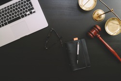 justice and law concept.Lawyer workplace with laptop and documents with dark wooden