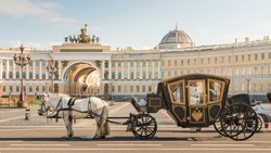 Russia, St. Petersburg City, Tsar Horse Carriage in front of Winter Palace Landmark Tourist Attraction at sunset in summer daytime, Hermitage Museum, Palace square