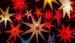 Colorful Christmas stars at a Christmas Market on black