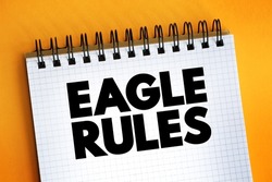 Eagle Rules text on notepad, concept background