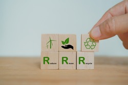 hand arranged wooden cube block over reduce, reuse and recycle text for save world, environmental concept