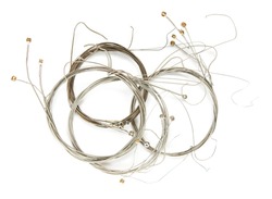 Old guitar strings, isolated on white, old guitar strings, coiled and bundled. 