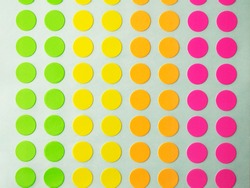 Sheet of circle labels or dot sticker in various neon colors. 
also called coding Dot Labels. Close-up macro from above. 