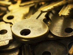 Many brass keys. Many brass keys extremely close up. Security and encryption, concept image. High magnification macro. 
