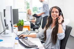 Attractive telephone worker customer service operator woman working in the office