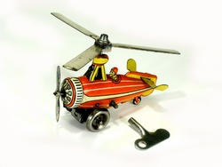 A small vintage Einfalt litho printed clockwork tinplate toy autogyro on white background.