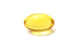 Close up golden color oil supplements in soft gel capsule, healthy product concept