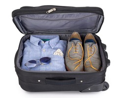 Man's suitcase packed for a short vacation or city trip
