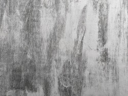 Close-up of vintage background with black brushstrokes on gray wall. Hand drawn subtle grunge texture.