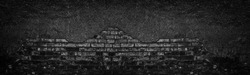 Black burnt brick wall with fallen off plaster wide texture. Crumbled old shabby brickwork. Dark gloomy large background