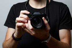 A small camera in the hands of a photographer.