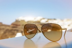 Vacation concept. Aviator sunglasses with touristic town background.