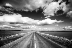 High contrast view of countryside road with dramatic sky