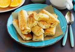 Fried rolls with dough filo and cheese curd cheese filling.