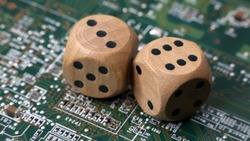 Two wooden dice on a green circuit board. Random numbers.