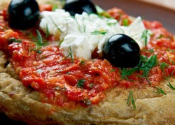 Dakos - slice  bread  topped with chopped tomatoes and crumbled feta.Cypriot cuisine