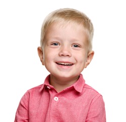 A 5-year-old boy with blond hair in a pink shirt laughs. isolated on a white background. A happy child. Baby teeth.