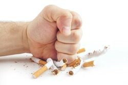 Human fist breaking cigarettes Anti smoking concept