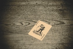 card with joker on the wooden floor