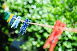 Set of clothes hangers located in the same position. The blue clothes stick is in focus