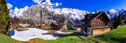Switzerland nature and travel. Alpine scenery. Scenic traditional mountain village Murren surrounded by snow peaks of Alps. Popular tourist destination and ski resort