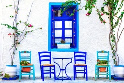 Traditional Greece series - small cute street taverns (bars), with typical wooden chairs. Kos island
