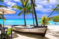 amazing tropical holidays. Beach seaside restaurant with old boat. Mauritius island