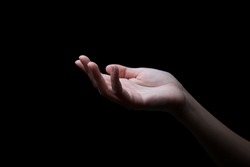 woman hands palms up over black background