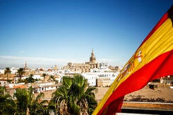 Seville cathedral with Spain flag in Sevilla , Spain
