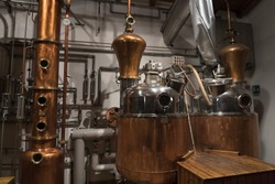 Copper still alembic inside distillery to distill grapes and produce spirits 