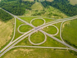 Top view of green roundabout with vehicle movement, Russia
